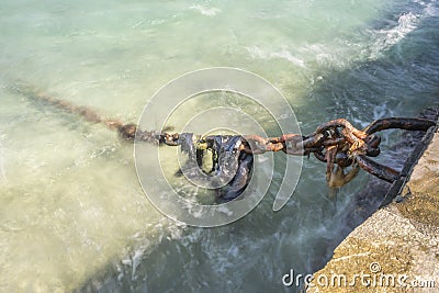 Rusty mooring chain Mykonos harbor Stock Photo