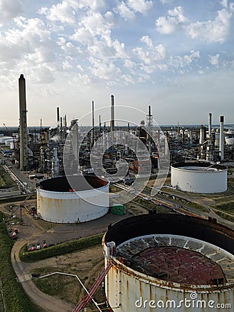 Rusty oil storage tanks at UK oil refinery with chimneys Stock Photo