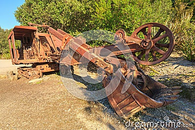A rusty old backhoe, or excavator, left out in nature Stock Photo
