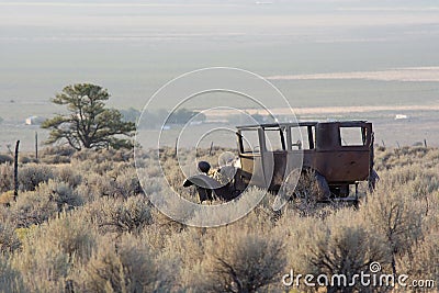 Rusty Old Jalopy Overlooking Sagebrush and Pinyon Pine Desert in Nevada Stock Photo