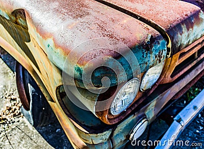 Rusty, old, junked car in the woods Stock Photo