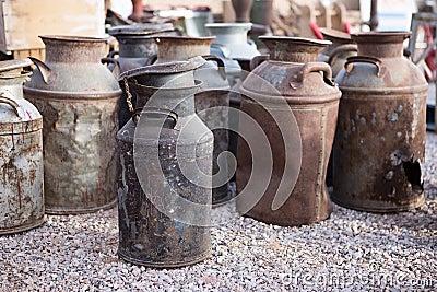 Rusty old milk cans at a flea market Stock Photo