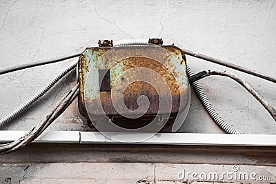 Rusty outdoor electrical box and corrugated wires Stock Photo