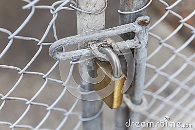 Rusty Padlock Attached to Caged Fence Stock Photo