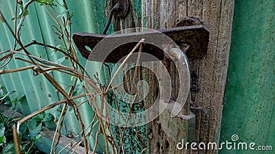 A rusty padlock iron hook and old wood Stock Photo