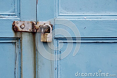 Rusty padlock on old painted wooden door Stock Photo
