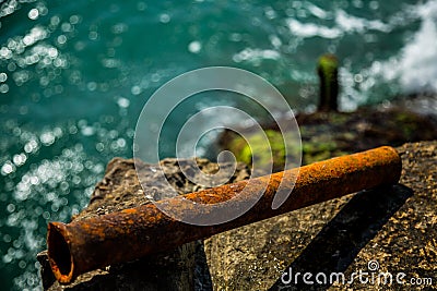 Rusty pipe on the background of Moss and sea Stock Photo