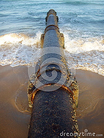 Rusty pipe on beach Stock Photo