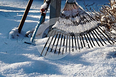 Rusty Rake on Snowy Ground Stock Photo