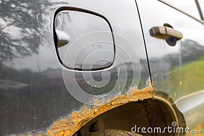 rusty rear fender of a car. corrosion of metal. Stock Photo