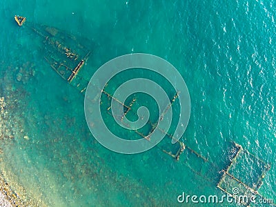 The rusty remains of the old sea dry cargo ship on the shallow water Stock Photo