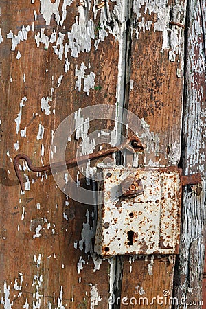 Rusty rural handmade lock on aged wooden shed door Stock Photo