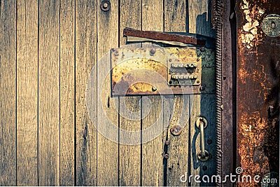 Rusty Security Lock at the Old Wooden Door Stock Photo