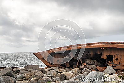 Rusty shipwrecked boat on a beach Stock Photo