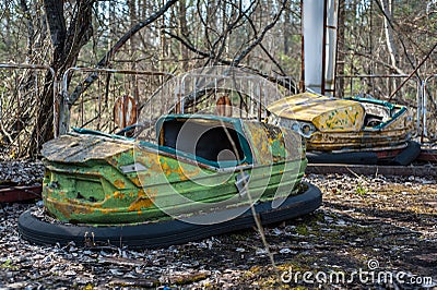 Rusty small children cars in abandoned amusement park in Pripyat, Chernobyl exclusion zone Stock Photo