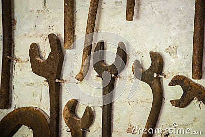 Rusty spanners on a wall Stock Photo