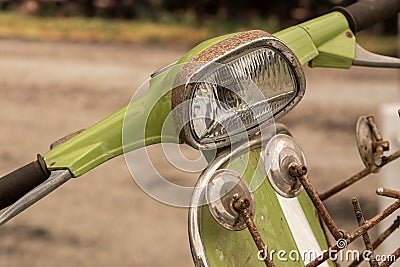 Rusty vintage mod green scooter bike handlebar, mirrors and headlamp Stock Photo