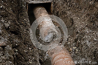 Rusty water pipeline in the trench ground view Stock Photo