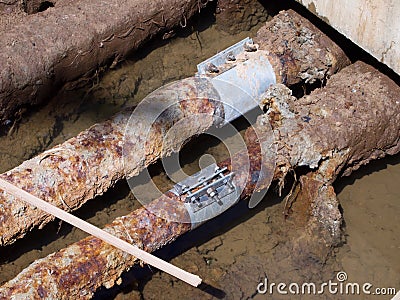 Rusty water pipes with embedded holes Stock Photo