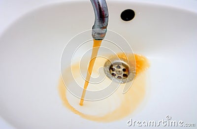 Rusty water running from a faucet Stock Photo