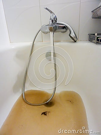 Rusty water running from a faucet Stock Photo