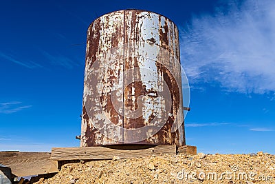 Rusty water tank abandoned in the Nevada desert Stock Photo