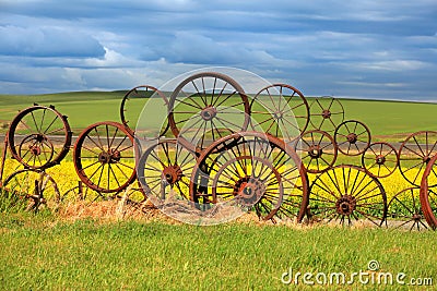 Rusty wheels fence Stock Photo