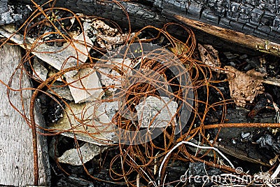 Rusty wire on burned boards Stock Photo