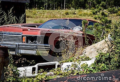 Rusty wreck of a historic american car on a meadow Stock Photo