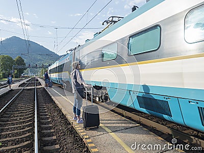 Ruzomberok, Slovakia, August 30, 2020: international train arrived at train platform with group of waiting people at Editorial Stock Photo