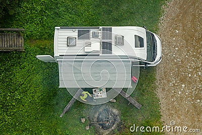 RV Park Pitch with Camper Van and Campfire Place Aerial View Stock Photo