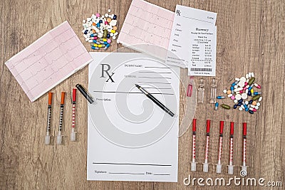 Rx blank with pills, syringe and pharmacy receipt Stock Photo