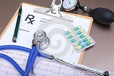 RX prescription, Red heart, pills, blood pressure meter and a stethoscope on table. Stock Photo