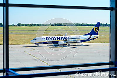 Ryanair plane seen through the window of Airport in Poznan Editorial Stock Photo