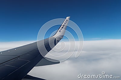 Ryanair wing tip on aircraft over clouds. Editorial Stock Photo