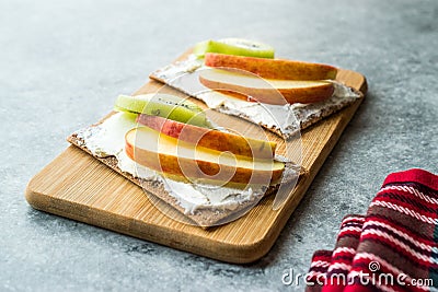 Rye Cripsbread with Cream Cheese, Apple Slices and Kiwi Fruit / Healthy Snacks Recipe Stock Photo