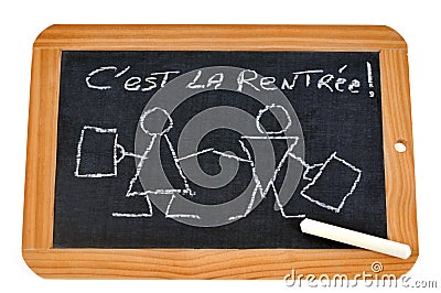 It`s back to school written in French on a school slate Stock Photo