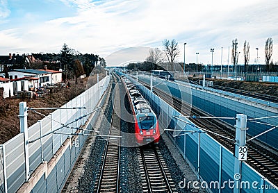 S-Bahn train traveling in the Bruck neighborhood in Erlangen, Germany on a sunny day Editorial Stock Photo