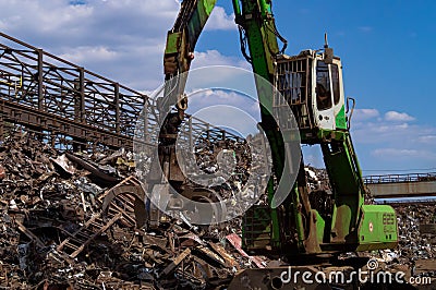 S Broom. Scrap metal loading. Mechanisms for loading scrap metal. Loading process. Stock Photo