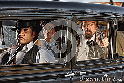 1920s Era Gangsters Drive By Stock Photo