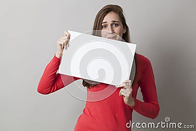 20s girl getting nervous at sending bad news or scared at received stressful information on blank banner Stock Photo