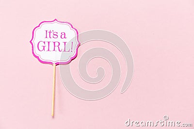 It`s a girl sign at the baby shower party. Pink solid background. Baby shower celebration concept Stock Photo