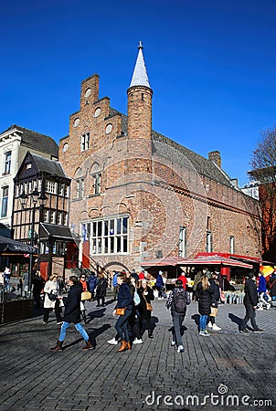 View over market square with restaurants on historic red brick house with VVV tourist information against blue winter sky Editorial Stock Photo