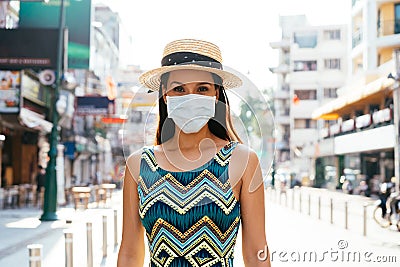 20s Hispanic Brunette woman in a protective mask wear summer sleeveless summ dress in Asia. Stock Photo