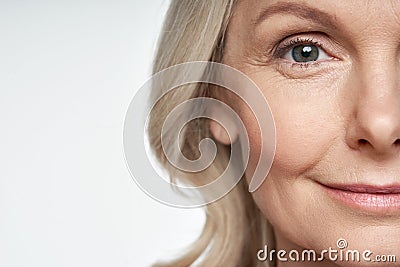 50s mid aged woman looking at camera. Anti age skin care. Half face crop Stock Photo