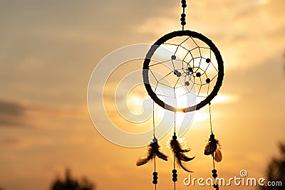 It`s a native American dream catcher and golden rays of the sunset Stock Photo