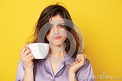 Rumpled young girl with cup of coffee Stock Photo