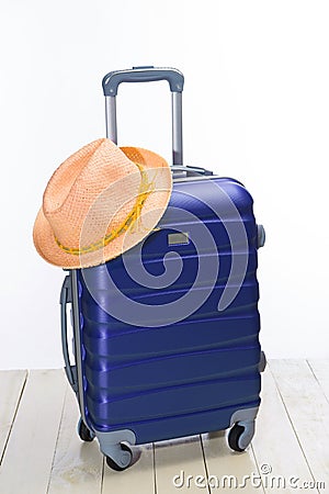 It`s summer time. Travel bag and straw hat. Stock Photo