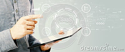 SaaS - software as a service concept with young man holding a tablet Stock Photo