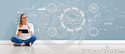 SaaS - software as a service concept with young woman using a tablet Stock Photo